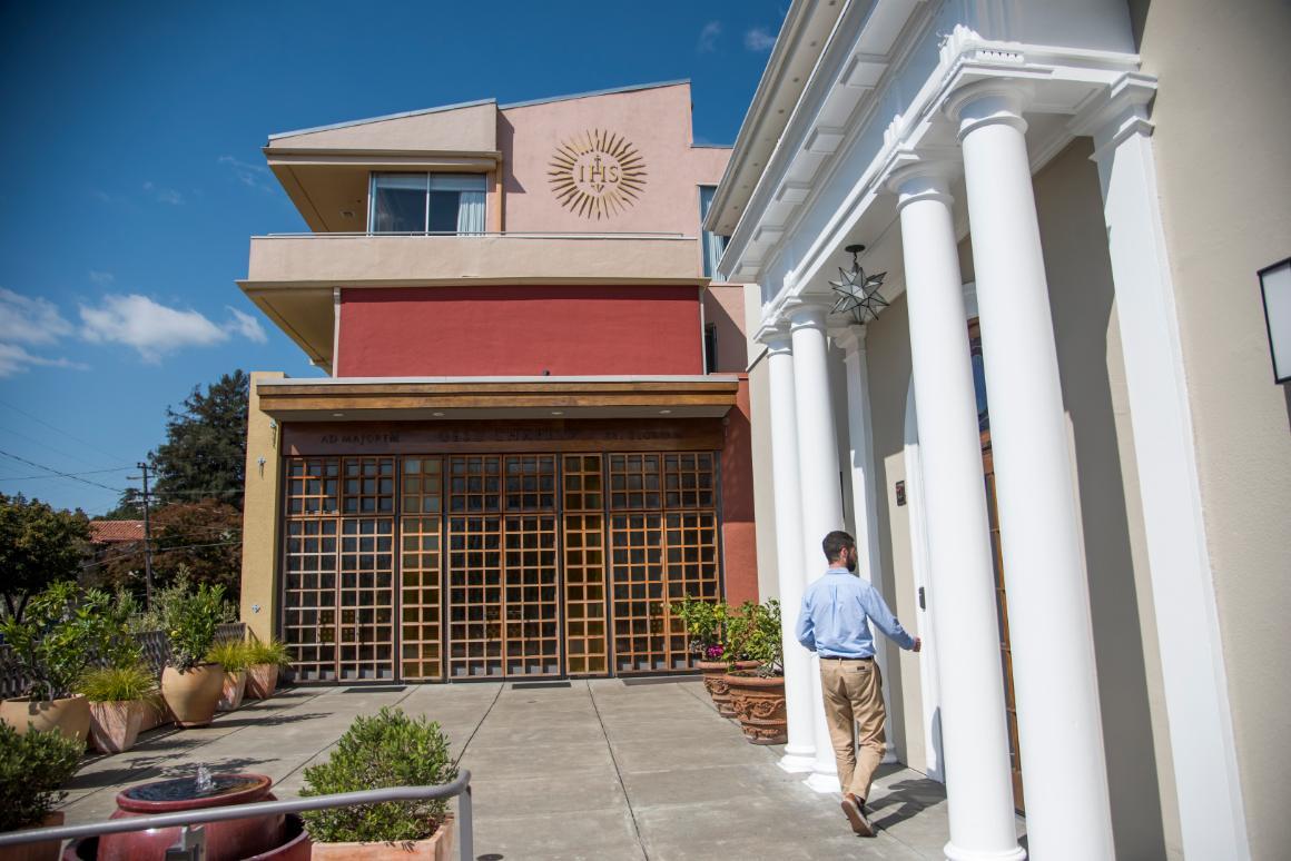 A person enters a building labeled Student Services.