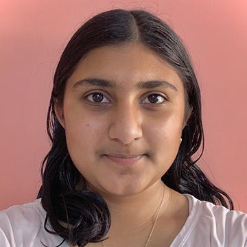 Woman with white headband and top smiling