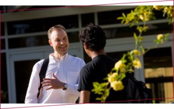 Leavey School of Business faculty engaging in lively discussions with a student