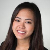 Smiling woman in professional attire against a plain background.