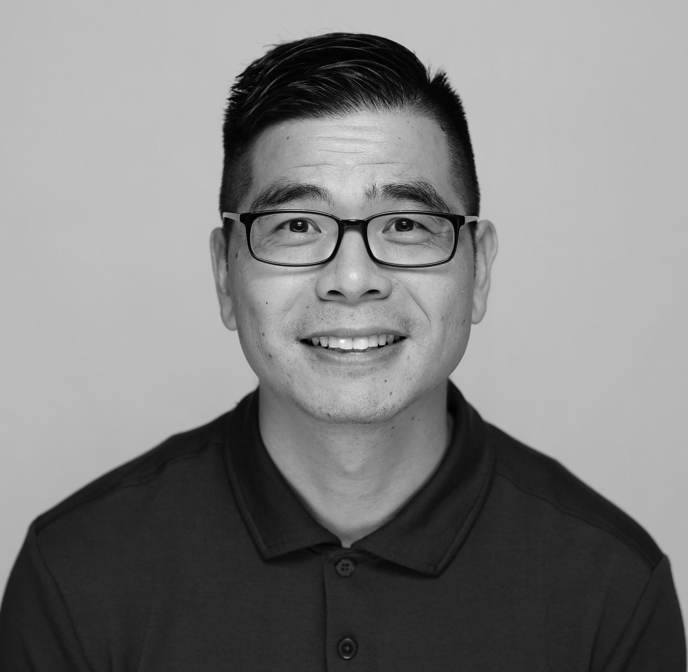 A smiling man wearing glasses