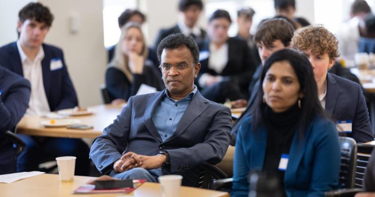 Panel judges listening intently to Leavey student international business case presentations