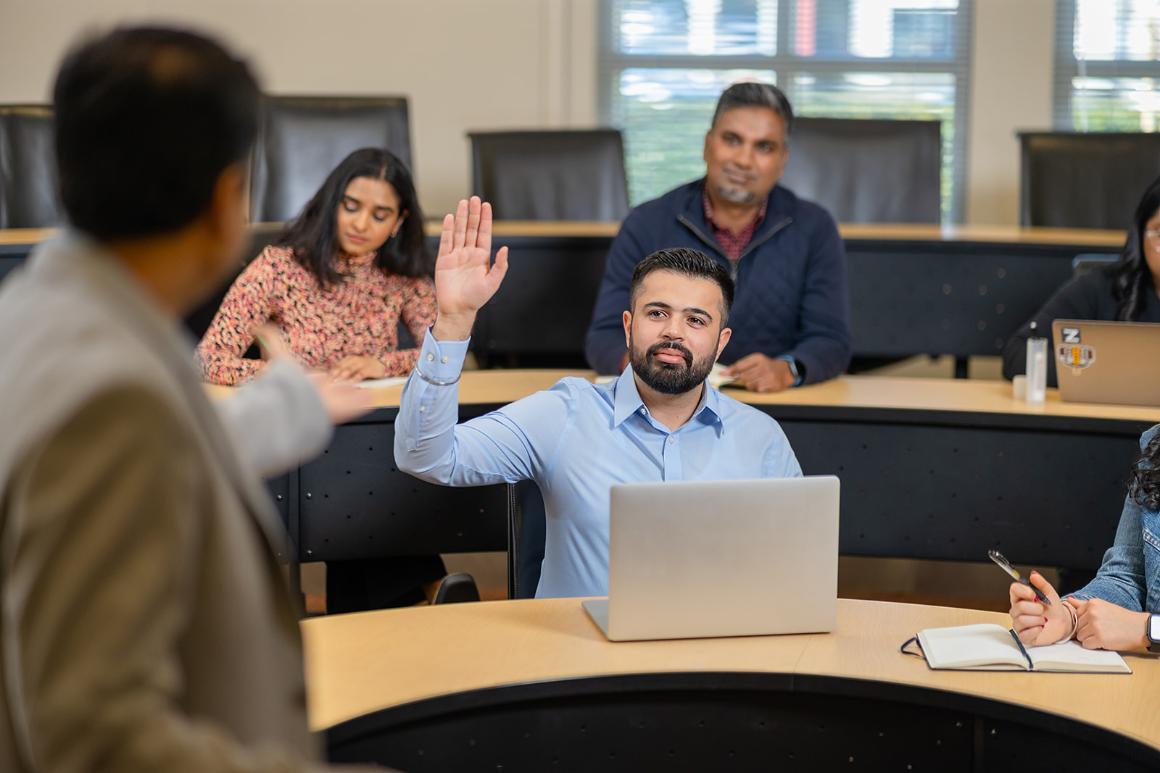 Leavey MBA candidate raising hand during class