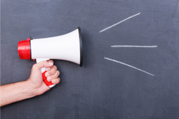 Photo of a hand holding a megaphone 
