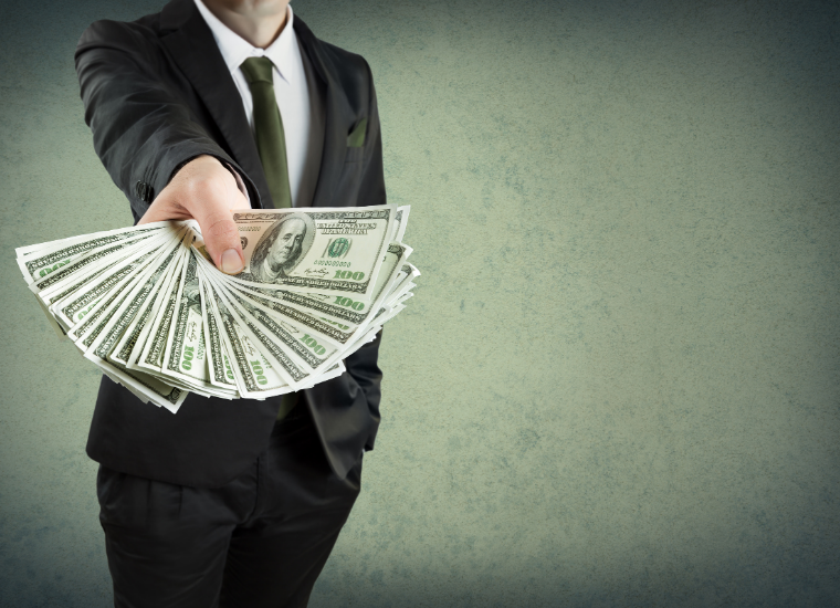 Photo of outstretched hand holding money