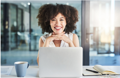 Welcoming woman sitting in front of laptop