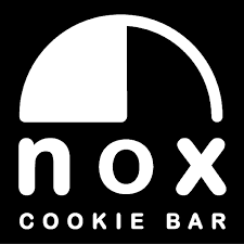 A black and white cookie sits atop the words nox cookie bar 