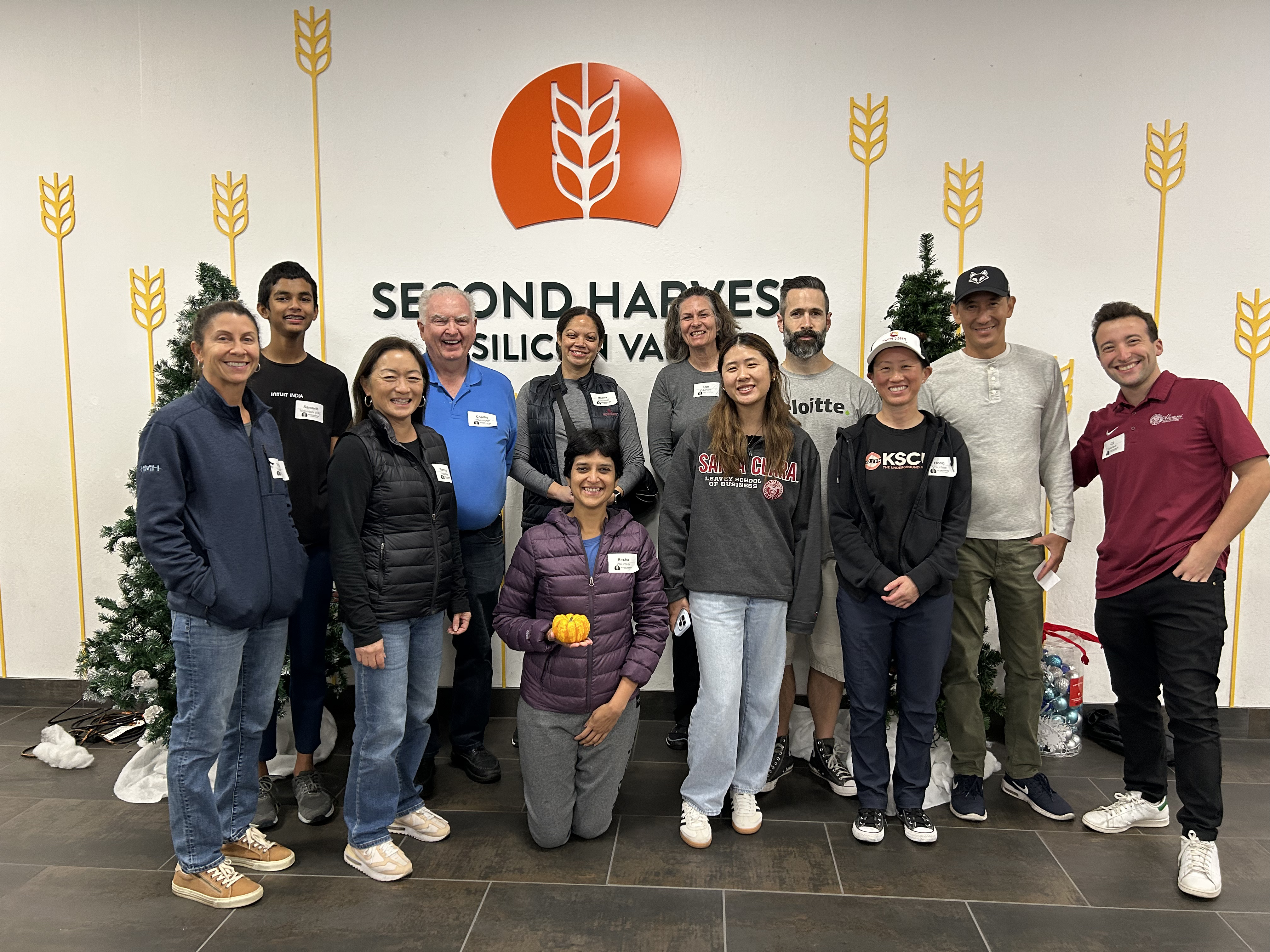 Alumni picture with Second Harvest logo in the background