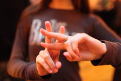 Person forming a hashtag symbol with their fingers.