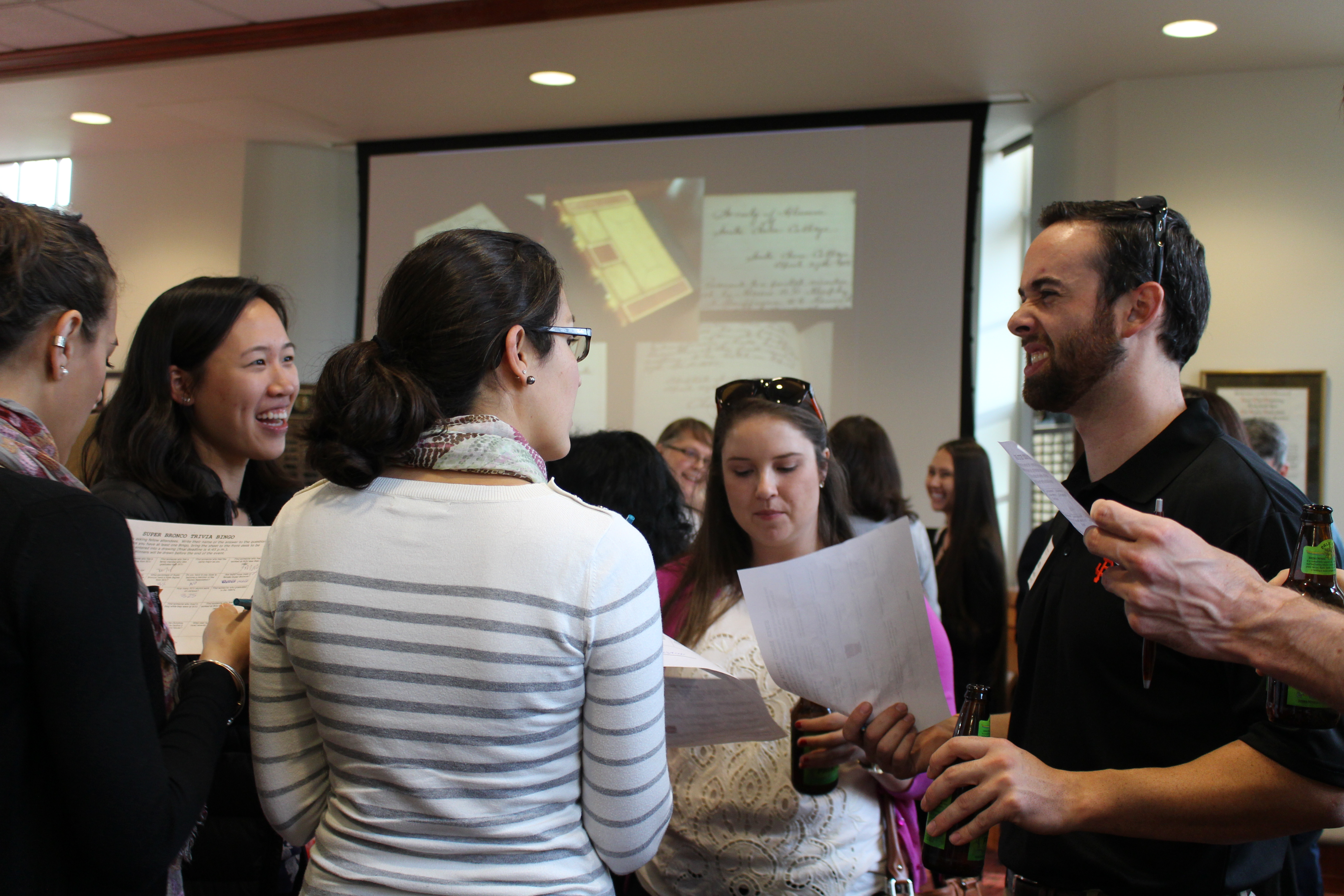 People engaged in conversation at the Super Broncos Icebreaker event.
