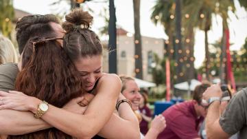 SCU alumni hugging 