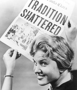 A person holding a newspaper titled TRADITION SHATTERED.