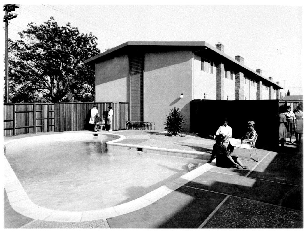 Women sitting by the pool at off-campus residence.