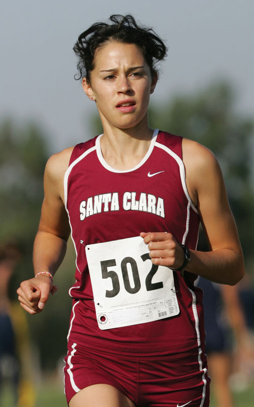 A person running, wearing a red Catholic jersey numbered 502.
