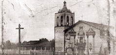 Historical university building with a cross statue in an old photograph. 
