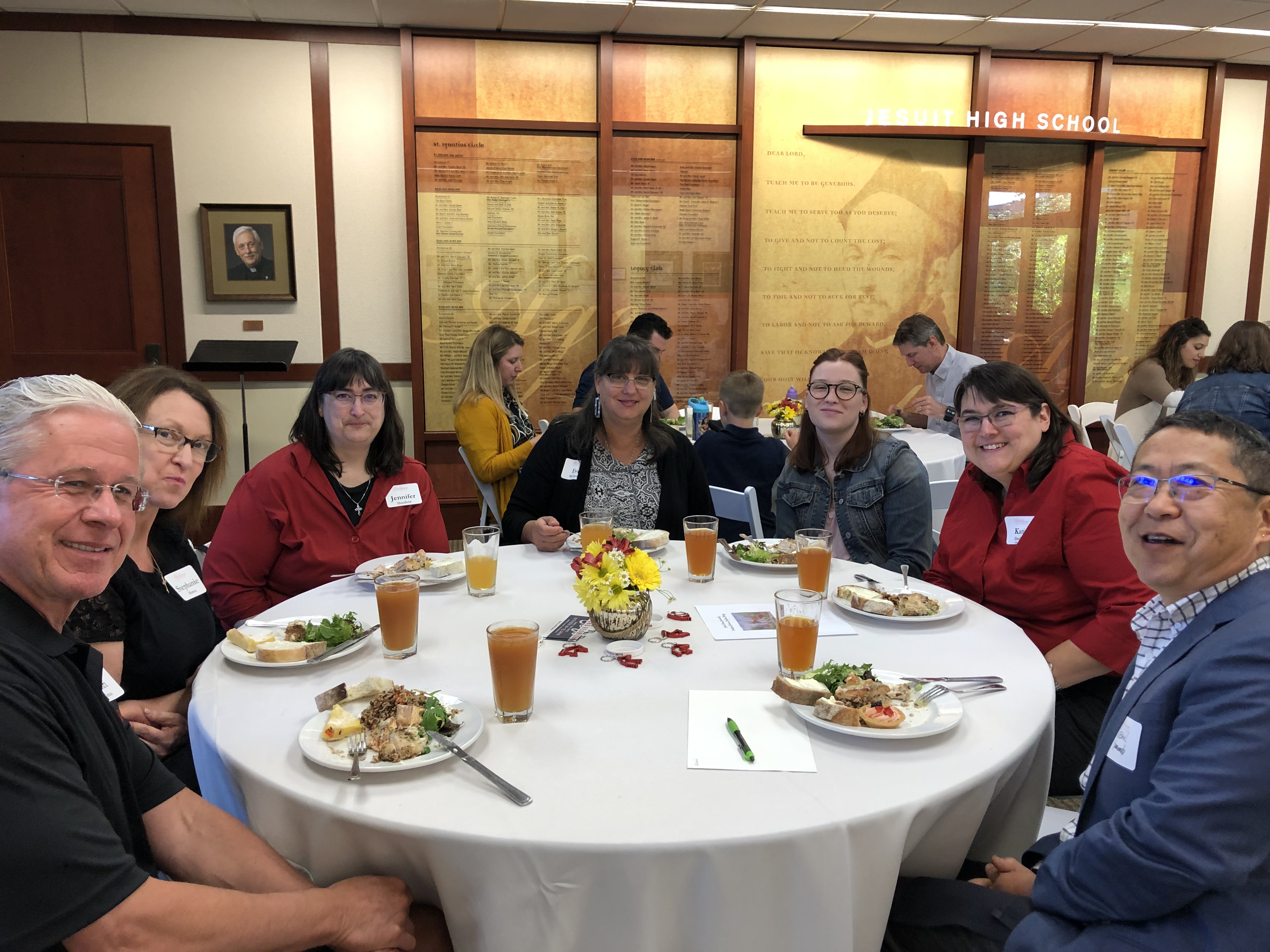 Portland community eating a dinner around a table