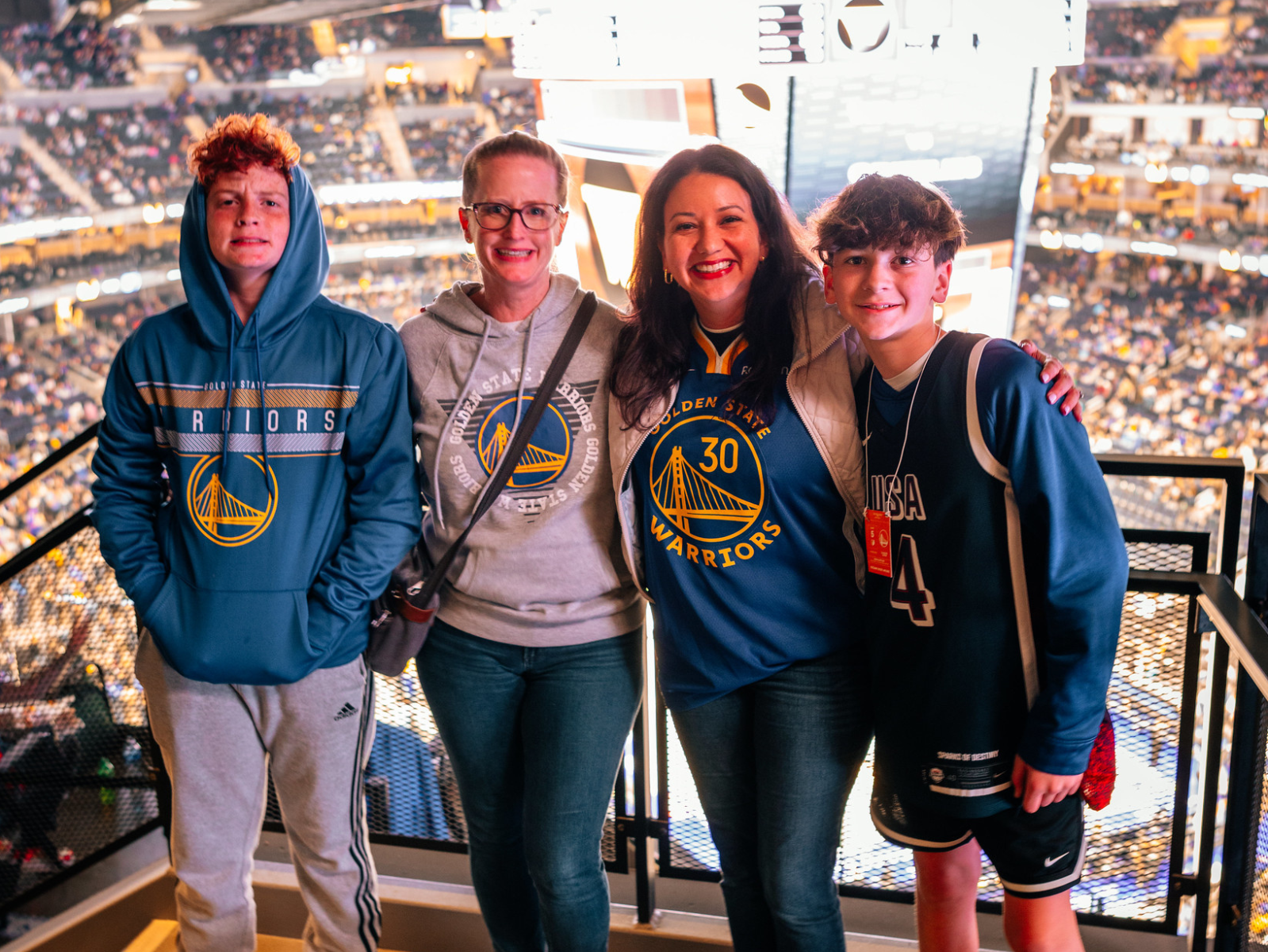 Peninsula alumni family at a Warriors game