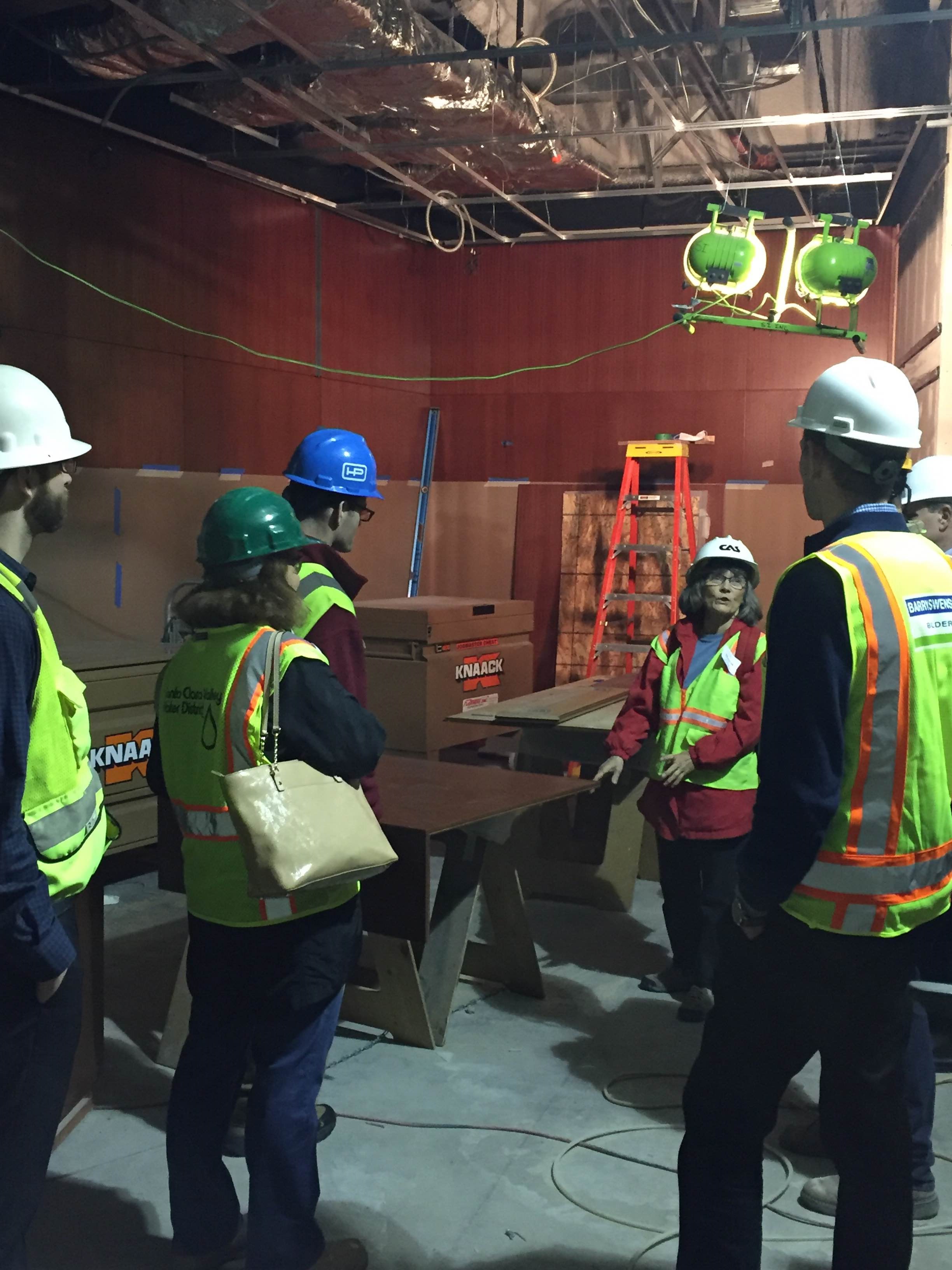 Group in safety gear at a construction site.