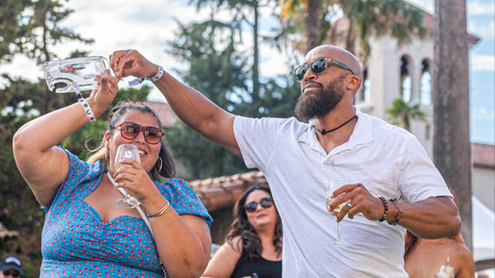Two alumni dancing in the mission gardens