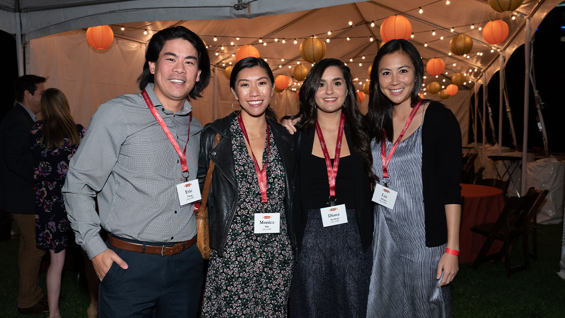 Four people smiling at the camera 