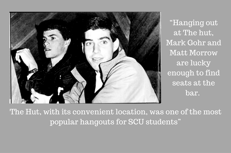 Black and white photo of two guys in a hut cabin.