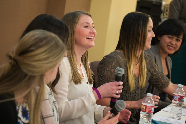 Several people seated at a table during a career prep bootcamp event.