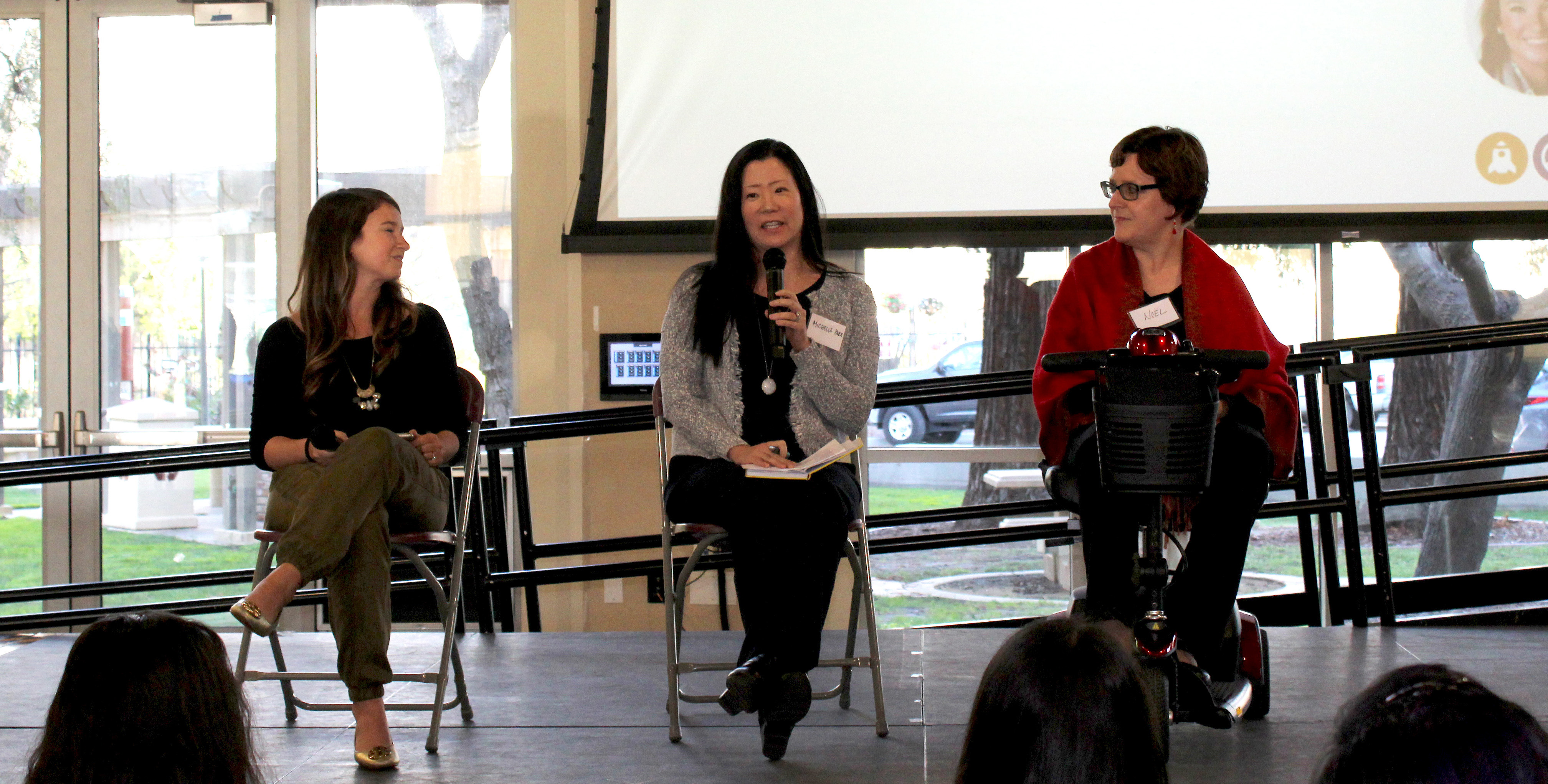 Three people sitting on stage at Diversity Works Expo 2019 panel discussion.
