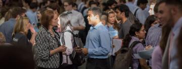 People gather in a crowded space, engaging and interacting.