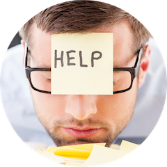 Person with glasses wearing a HELP sticky note on their forehead.