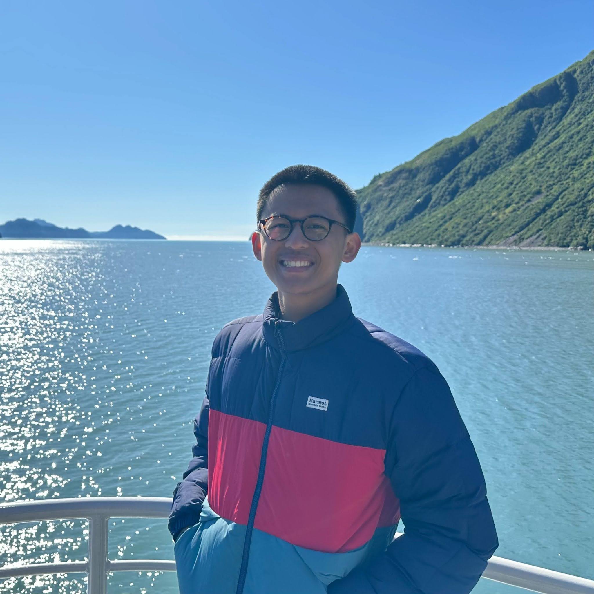 A student standing in front of water