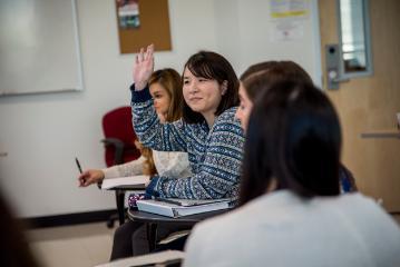 Student raises their hand in class