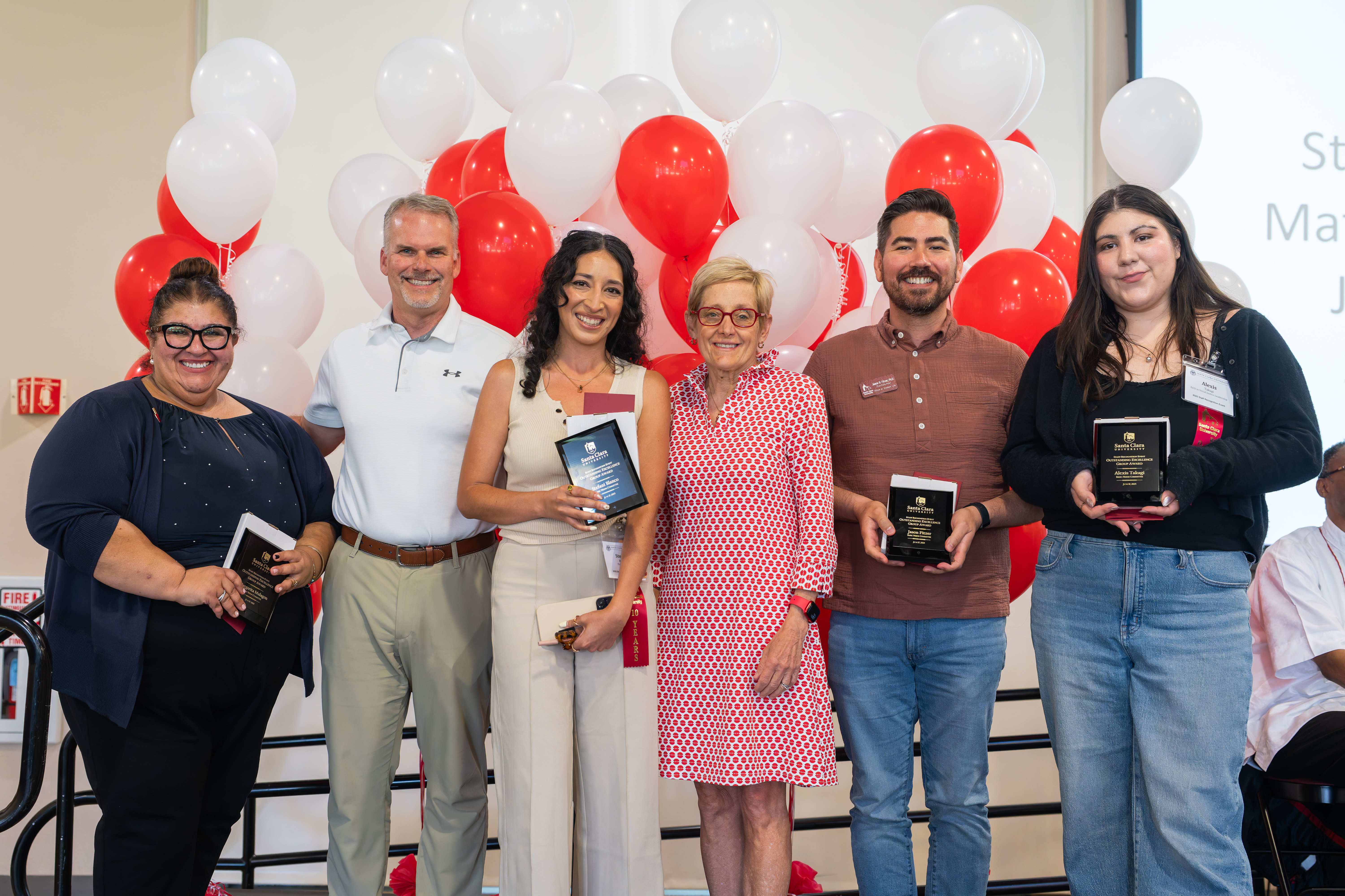 Staff members posing with awards