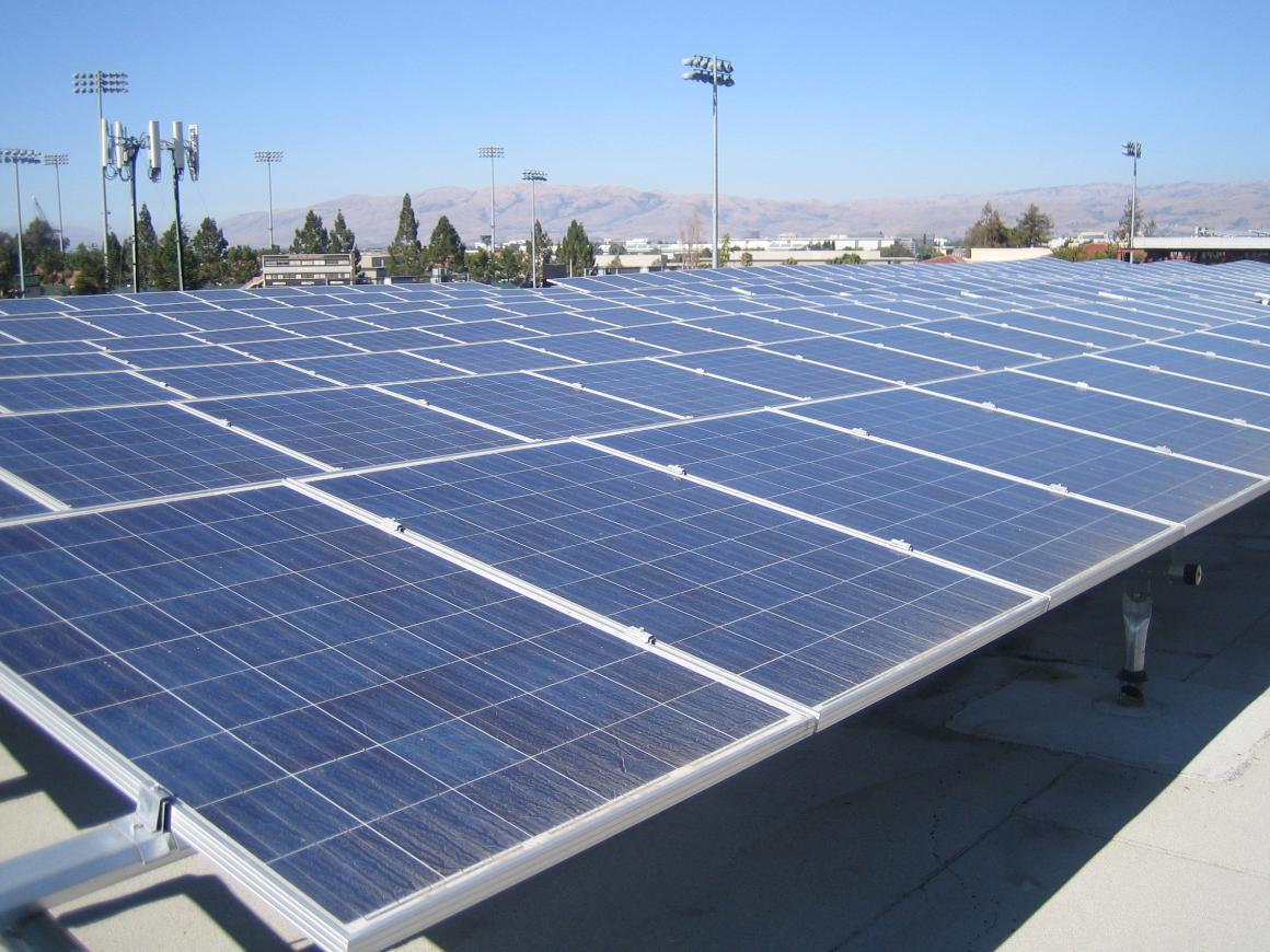 Large array of solar panels under clear sky.