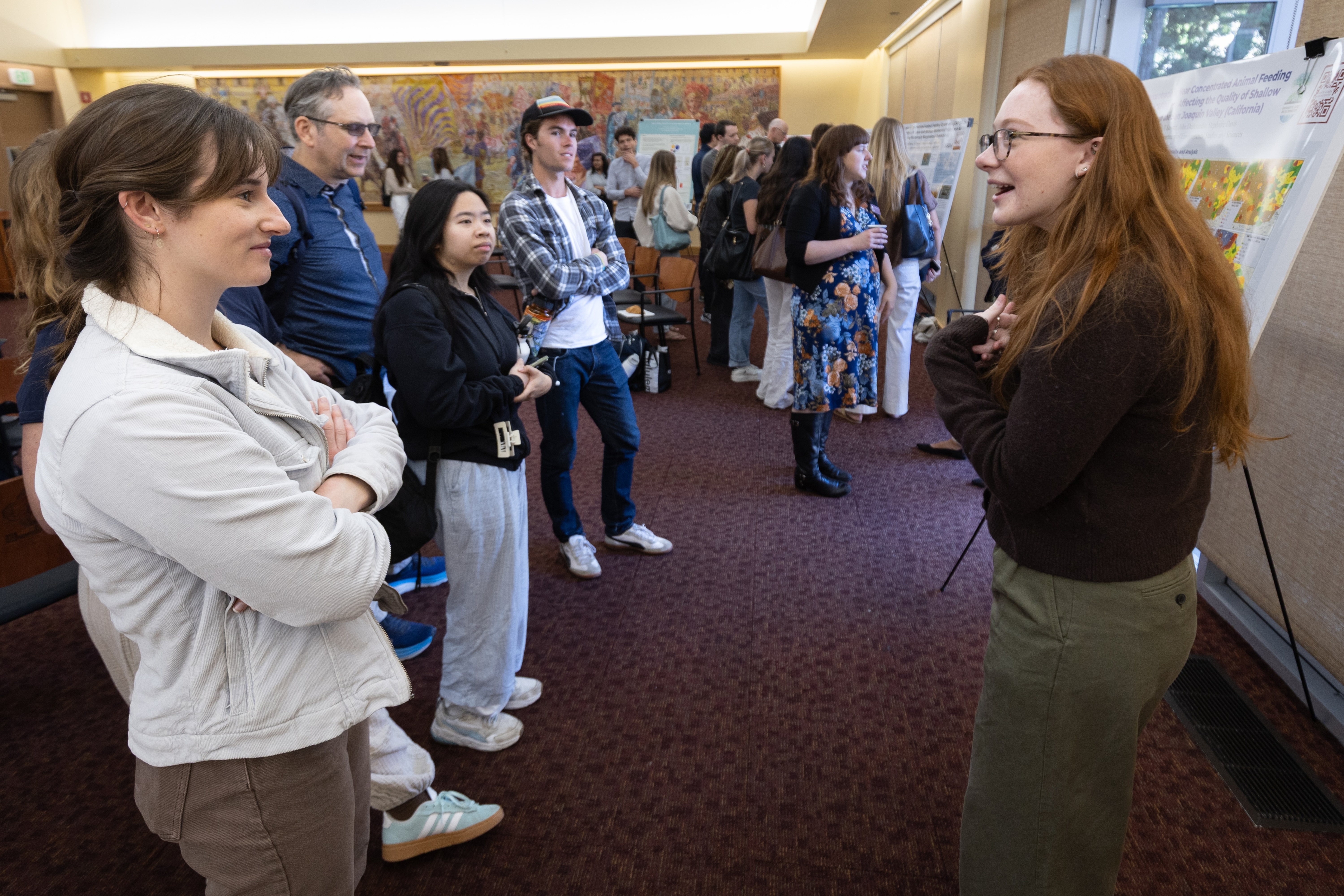 A student shares their research poster during the 2025 Sustainability and EJ Symposium.