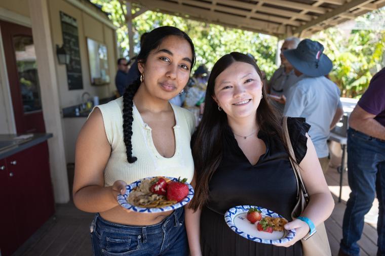 2025 Sustainability Celebration: Two students enjoying refreshments