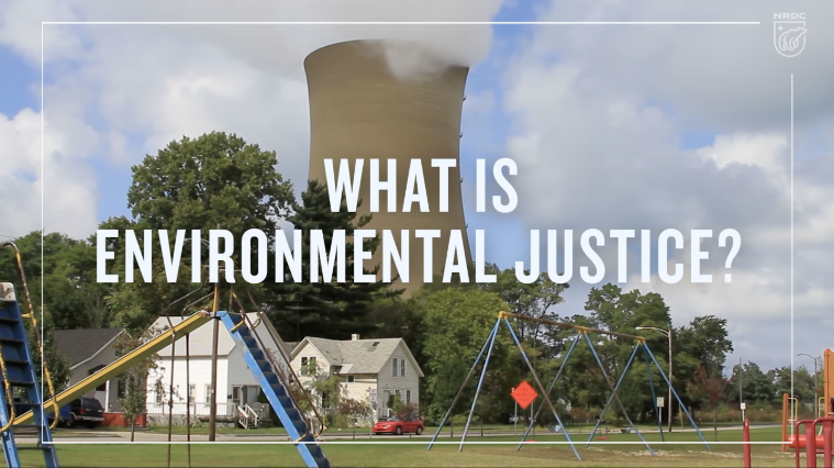 The title What is Environmental Justice? written over a photo of a children's playground with a large smokestack looming behind it