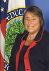 A person stands in front of an Education Department emblem. image link to story