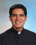 A smiling man in clerical attire. image link to story