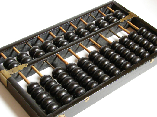 Traditional wooden abacus with black and white beads.