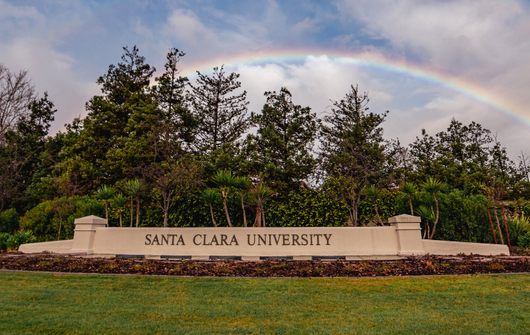 A rainbow appears above the Santa Clara University entrance sign image link to story