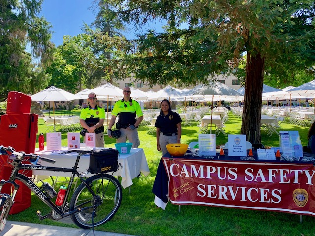 Campus Safety Services booth at an outdoor staff fair.