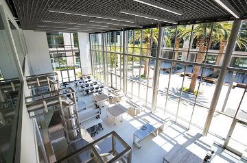 Innovation Zone classroom displaying many industrial equipments with a view to the outdoor courtyard 