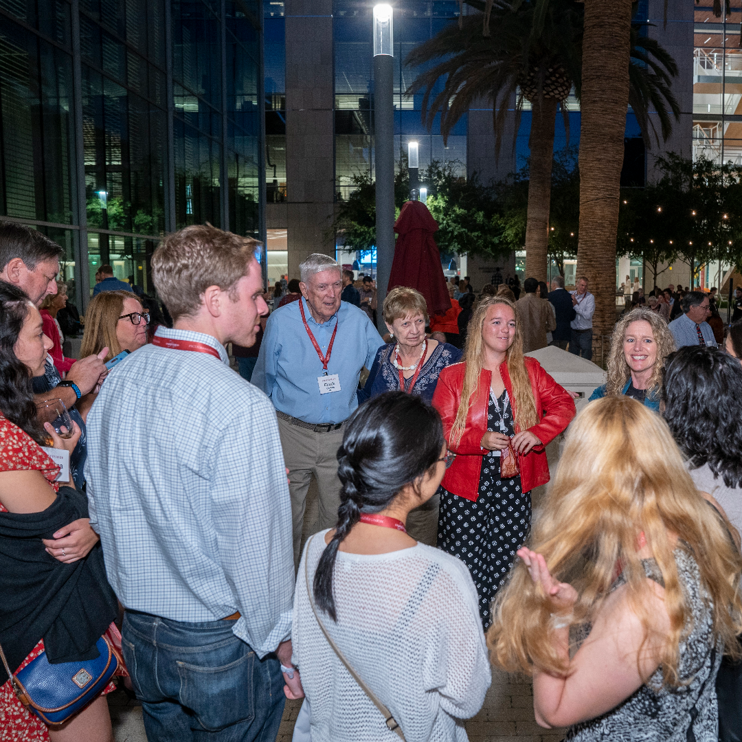 People socializing at an evening event named Grand Bash 2022.