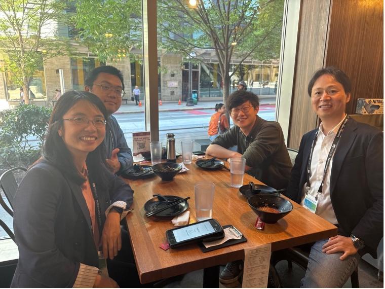 four people sitting at a table