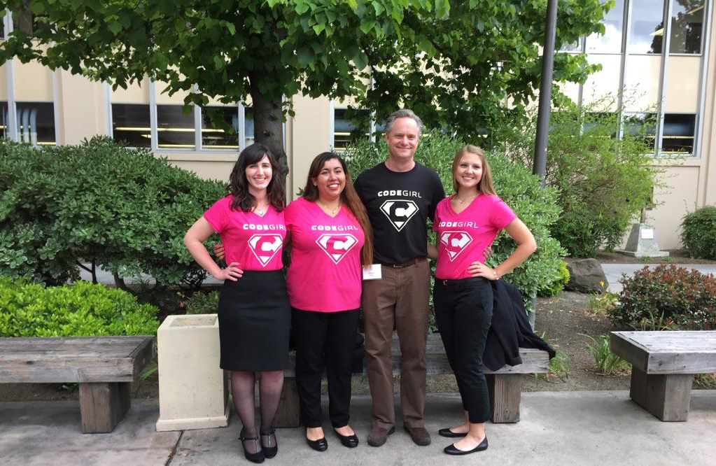 Web Design and Engineering students, Amanda Holl, Tracey Acosta, and Paige Rogalski, pose with faculty advisor, Darren Atkinson after winning their 2015 Senior Design session for their project Code Girl, a web-based application that allows girls aged 5 to 8 to create their own avatar doll and unlock accessories by successfully completing challenges using a visual coding editor.