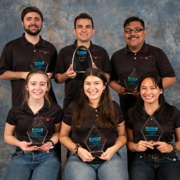 Six people holding '2022 First Place AGC Mixed Use' awards.