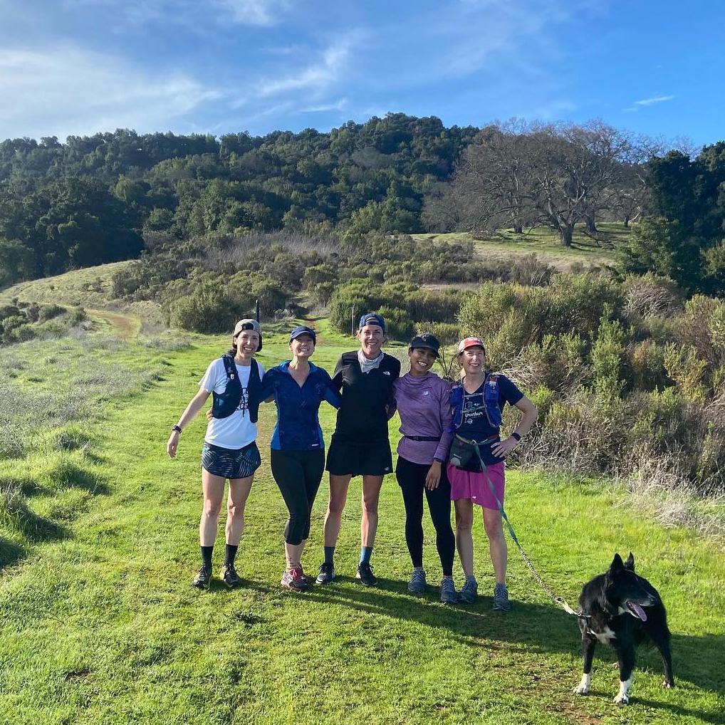 Runners participating in the SCU EWB 5K for 5K posing on a beautiful hilltop trail