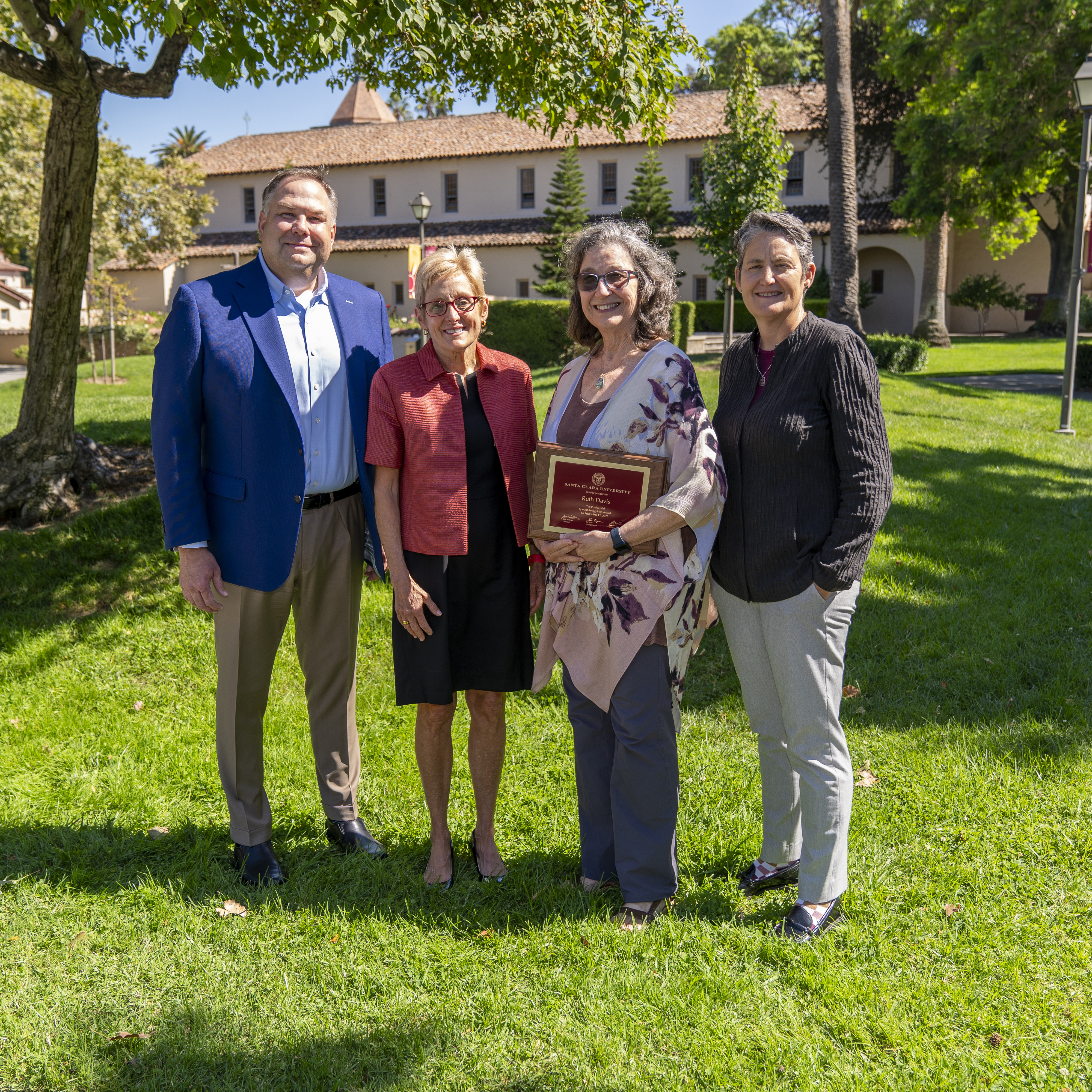 A photo of Ruth Davis with the Provosts holding the President's Special Recognition Award