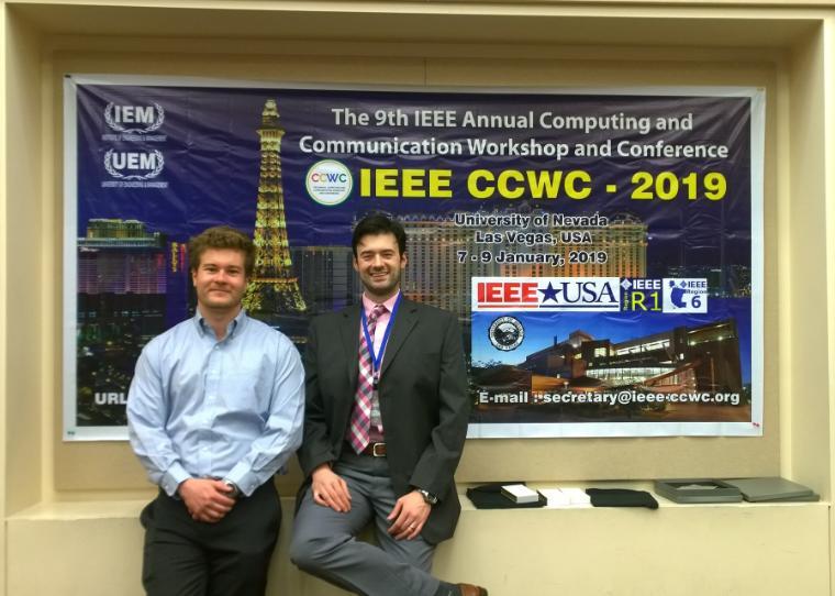 Two men smile in front of HA CCWC and sponsor logos.