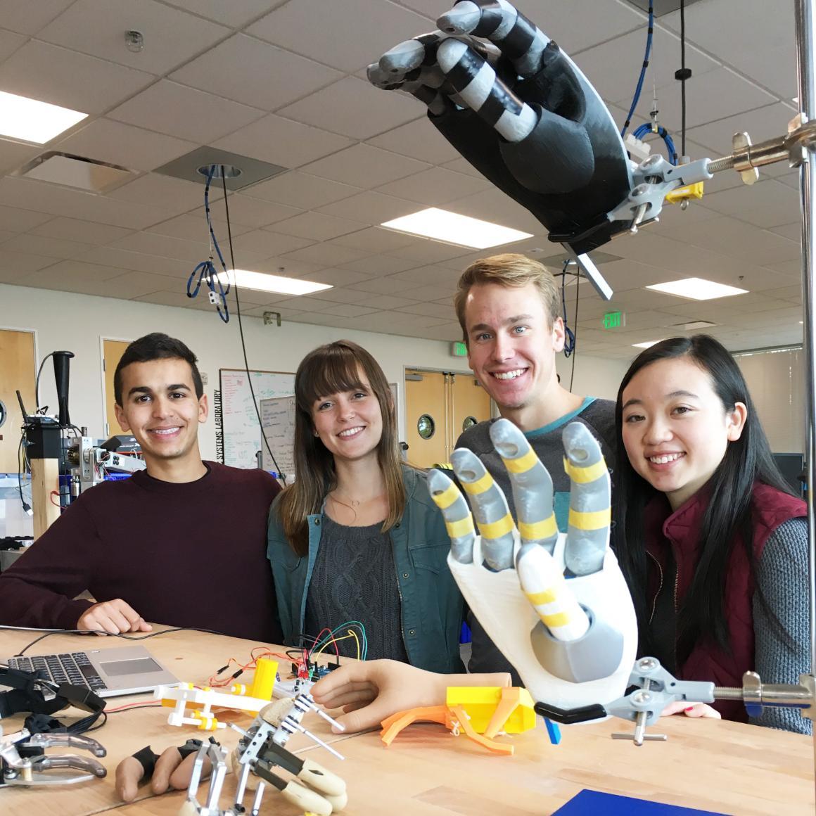 Michael Mehta, Jamie Ferris, Evan Miscuraca, and Shiyin Lim at work on the HELP Hand